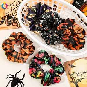 Detailed flat lay of Halloween themed scrunchies featuring pumpkin and ghost patterns