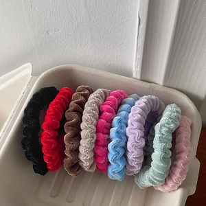 9-piece set of velvet scrunchies in multiple colors including red, pink, and blue