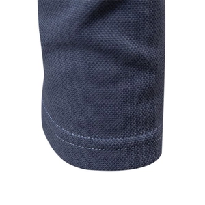 Navy blue men's cotton polo shirt showing premium stitching and pique knit fabric texture
