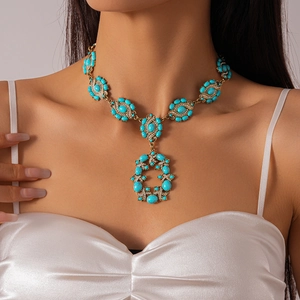 Macro shot of Bohemian vintage necklace with turquoise stones and gold metal detailing