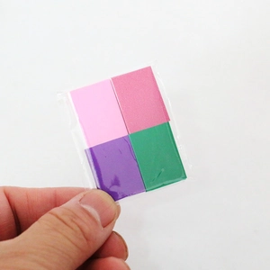 Close-up of four colorful miniature dollhouse books in a clear pack for BJD scenes