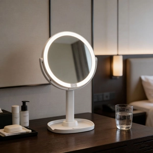 Detail of white round LED makeup mirror with storage base and touch sensor button