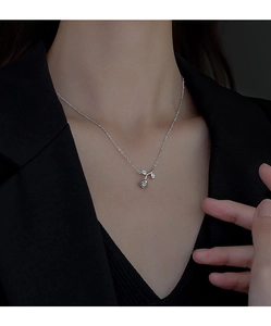Close-up of S925 sterling silver rose pendant with zircon leaves on a delicate chain