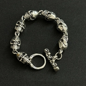 Detailed close-up of retro silver skull link bracelet with vintage T-bar toggle clasp
