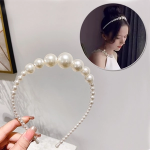Dettaglio di cerchietto con perle sfumate di varie dimensioni per acconciature moda