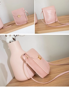 Front and back views of a pink crocodile pattern crossbody phone bag with gold clasp