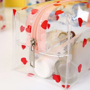 Transparent PVC makeup bag with red hearts and pink zipper for travel storage