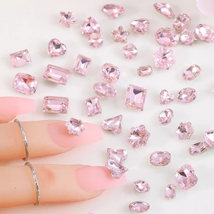 Macro shot of assorted pink rhinestones in various shapes for luxury nail art design