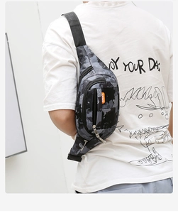 Macro shot of camouflaged tactical bag with orange SPORT label and adjustable strap