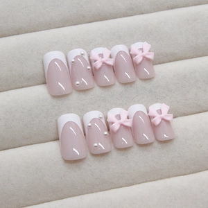 French tip press-on nails with 3D pink bows and micro pearls on a soft nude base