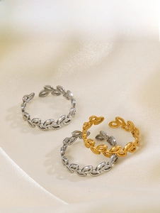 Detailed view of adjustable leaf and olive branch rings in gold and silver steel