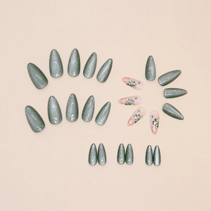 Almond-shaped cat eye press-on nails with sage green magnetic finish and clover floral art