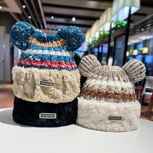 Detailed close-up of knitted beanies with plush faux fur trim and cute bear ear accents