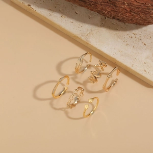 Detailed view of 6-piece gold-toned minimalist ring set with star and heart motifs