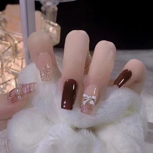 Elegant deep brown and tweed press-on nails with white bow and pearl decoration