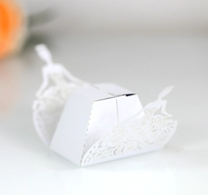 Laser-cut white wedding favor box featuring elegant hollow bride silhouette designs