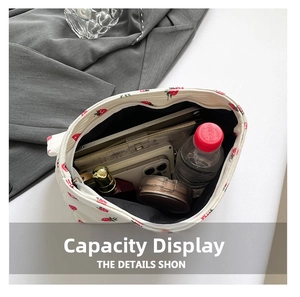 Internal view of strawberry print makeup bag showing large capacity for cosmetics and phone
