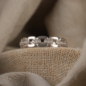 S925 sterling silver chain ring with cubic zirconia on beige fabric texture