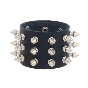 Close-up of black leather punk bracelet with three rows of silver metallic spikes