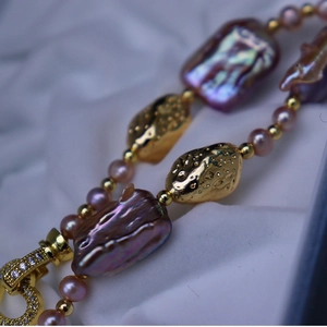 Elegant baroque pearl bracelet with pink pearls and textured gold beads on white silk