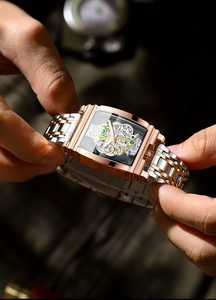 Close-up of rose gold tonneau watch featuring a hollow mechanical movement and gears