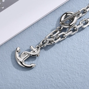 Detail of silver anchor pendant and toggle clasp on a nautical chain bracelet