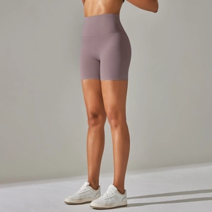 Detail shot of dusty pink high-waisted yoga shorts showing wide waistband and fit
