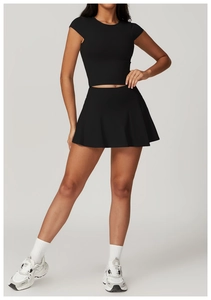 Detail of high-waist black athletic skirt and cropped top set with high elasticity fabric