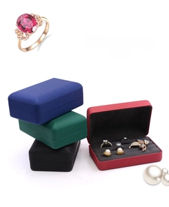 Macro shot of multi-color jewelry boxes with velvet lining and a ruby ring detail