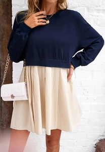 Détail d'un sweat-shirt bleu marine à manches longues avec ourlet plissé beige