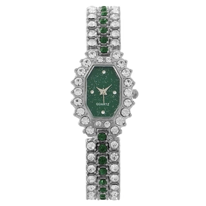 Elegant silver watch with green dial and rhinestones displayed on a white background