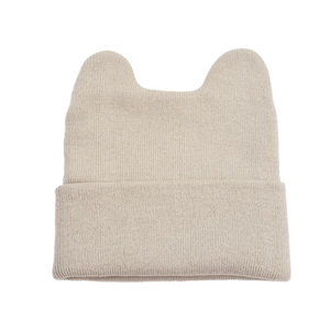 Detail of beige knitted beanie featuring vertical rib texture and cute cat ear design