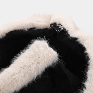 Macro detail of plush faux fur trim with black quilted lining and adjustable cord lock