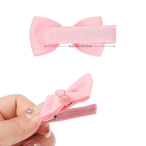 Detail of pink 1.8 inch grosgrain ribbon bow with a durable metal alligator clip back