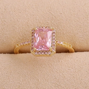 Elegant gold ring with a rectangular pink zircon center stone and halo setting