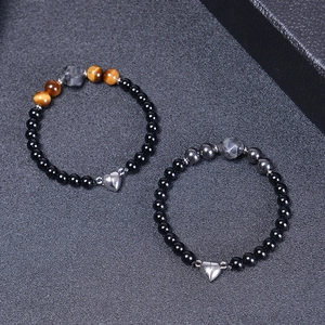 Close-up of magnetic heart clasp on natural black stone couples bracelets