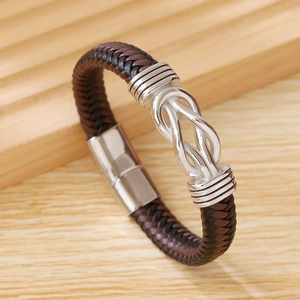 Close-up of brown braided leather bracelet with silver metal knot and magnetic clasp