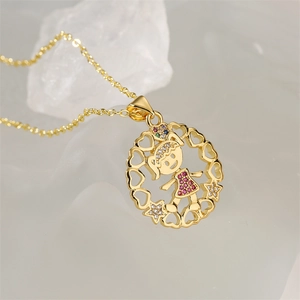 Macro detail of gold girl pendant with colorful crystals and heart patterns