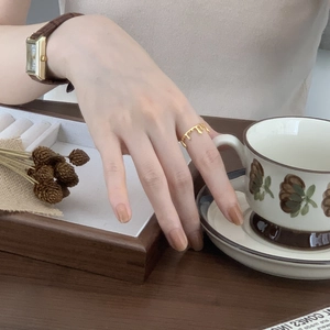 Chic gold lava drop ring styled with a vintage watch and floral coffee cup