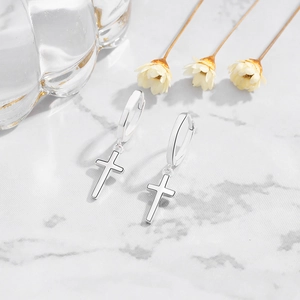 Minimalist S925 sterling silver cross hoop earrings on elegant marble background