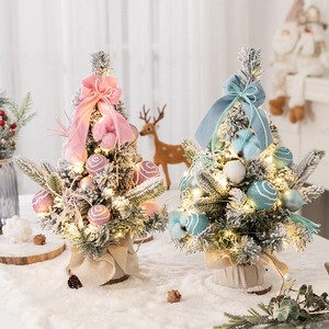 Flocked mini Christmas trees in pink and blue with LED lights for tabletop decor