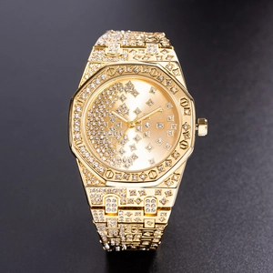 Macro detail of luxury gold watch with full diamond setting and date window