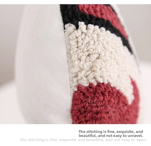 Macro view of dense tufting texture and geometric embroidery on the cushion cover