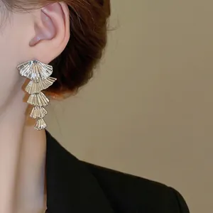 Elegant silver tassel earrings with tiered shell texture for a modern fashion look
