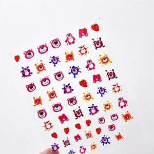 Detailed macro view of 3D embossed Lotso bear nail stickers with strawberry patterns