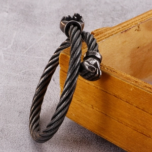 Close-up of retro punk steel cable bracelet with boxing glove motifs in antique silver finish