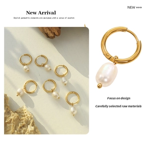 Detailed view of French vintage gold hoops with iridescent freshwater pearls on stone background