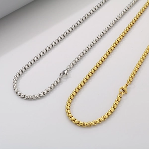 Polished gold and silver stainless steel box chains with lobster clasps on white background
