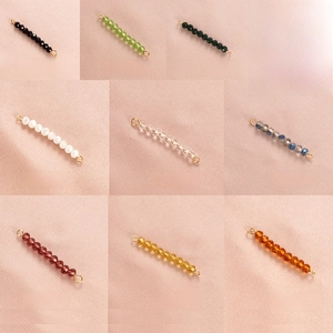 Detail view of 10 colorful 4mm glass bead connectors with gold loops for DIY jewelry