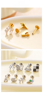 Flat lay of F136 titanium stud earrings featuring butterfly, tower and airplane designs